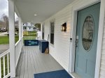 Main porch entry with storage for outdoor games and supplies